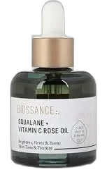 Biossance Squalane + Vitamin C Rose Oil in a clear glass dropper bottle with golden oil