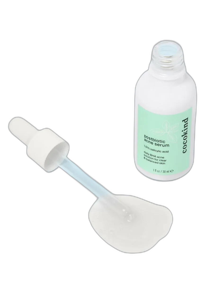 Cocokind Postbiotic Acne Serum in white-coated glass dropper bottle with minimalist branding