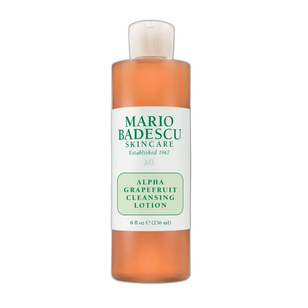 Mario Badescu Alpha Grapefruit Cleansing Lotion in a clear bottle with orange liquid