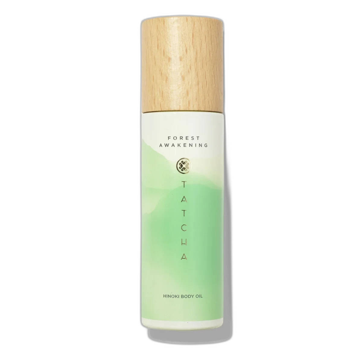 Tatcha Hinoki Body Oil glass bottle with pump dispenser in purple packaging