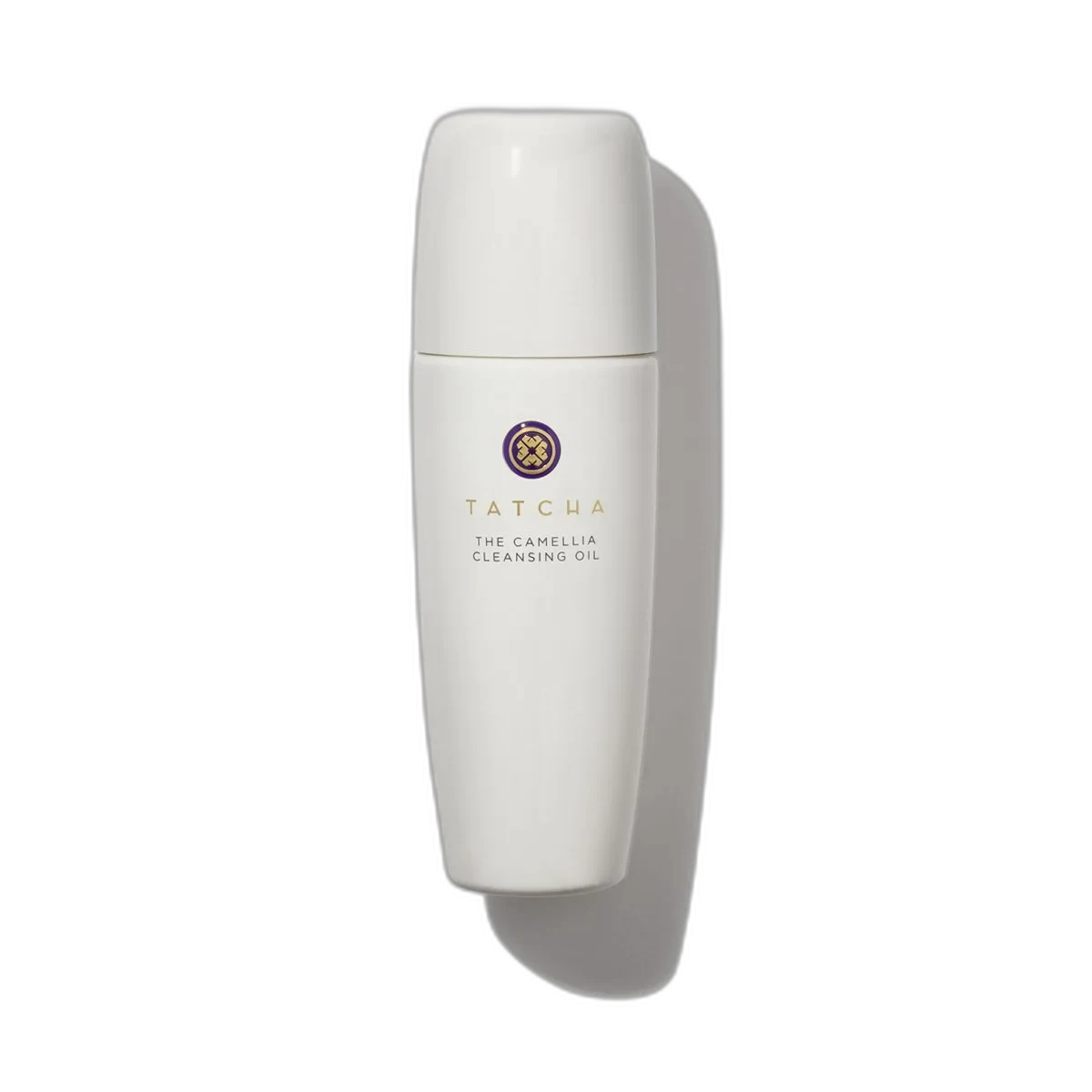 Tatcha The Camellia Cleansing Oil in a frosted glass bottle with gold pump dispenser